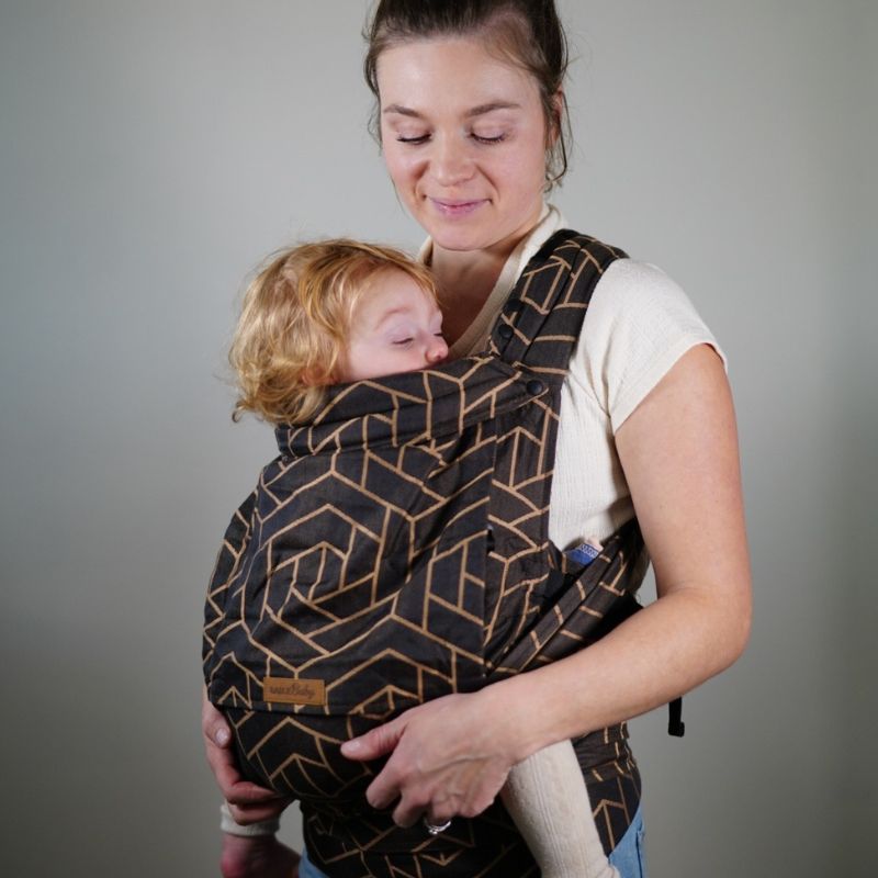 Babuebaby carrier in fractal worn on the front with baby supported, mom looking at baby