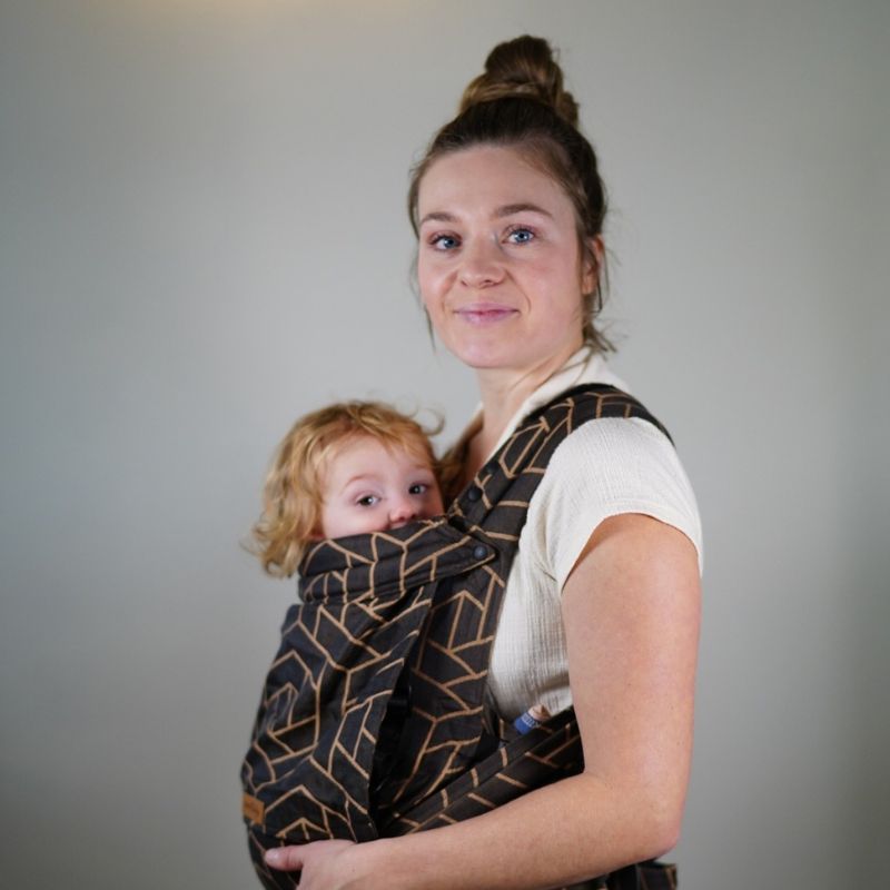 Babuebaby carrier in fractal worn on the front with baby supported, side view