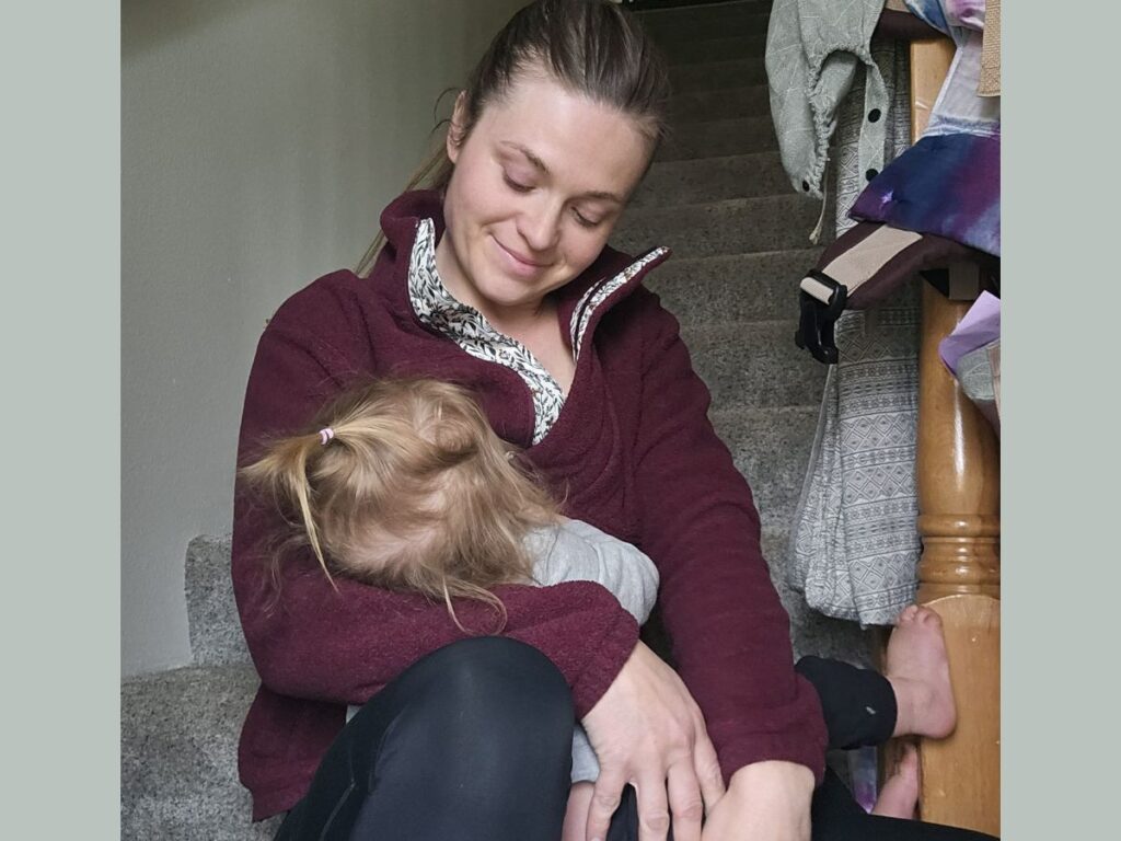 on stairs wearing Wildelore sweater